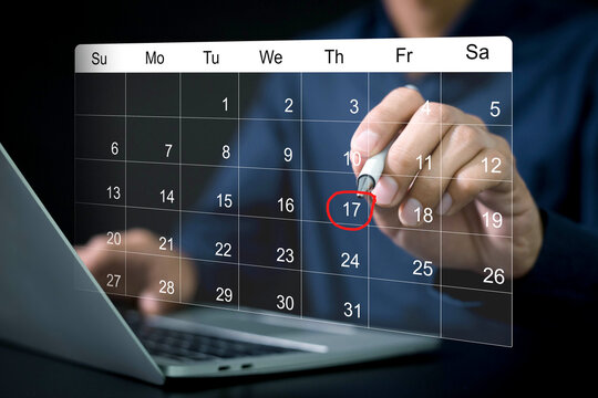 Businessman manages time for effective work. Calendar on the virtual screen interface, Businessman making red circles on important days on the calendar Important appointment dates