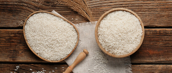 Bowl and plate with raw rice on wooden background