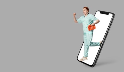 Hurrying female doctor with first aid kit and big smartphone on grey background with space for text
