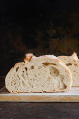 Slices of  homemade bread on wooden cutting board.