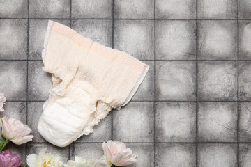 Period panties with flowers on dark tile background