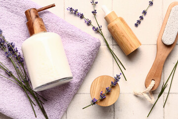 Composition with cosmetic products, bath supplies and lavender flowers on light tile background