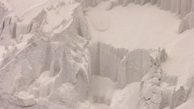 White heap pile of salt granules of phosphoric (phosphate) fertilizers on chemical plant.  Organic chemical fertilizers in production plant warehouse 
