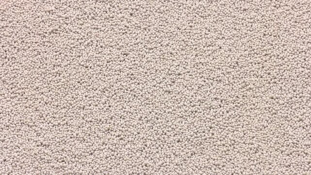 White heap pile of salt granules of phosphoric (phosphate) fertilizers on chemical plant.  Organic chemical fertilizers in production plant warehouse 
