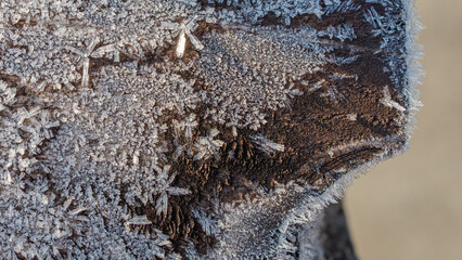 On a very cold winter morning, the wooden fence was covered with frost.
