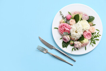 Beautiful table setting with floral composition on color background