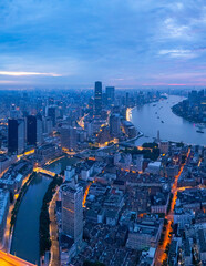 Fototapeta premium Aerial View of Shanghai skyline at sunrise with the Winding River