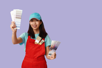 Female Asian painter with brushes and paint color palettes on purple background