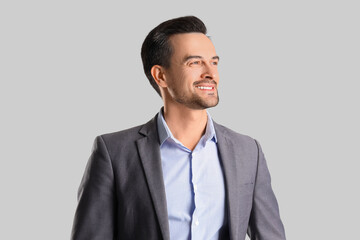 Handsome businessman in suit on light background