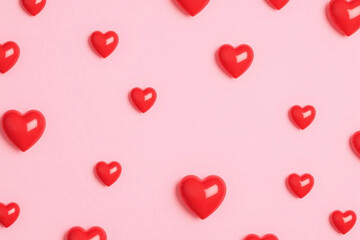 repeating pattern of bright red hearts on smooth light pink background
