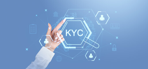 Businesswoman interacting with virtual KYC holographic interface on blue background.