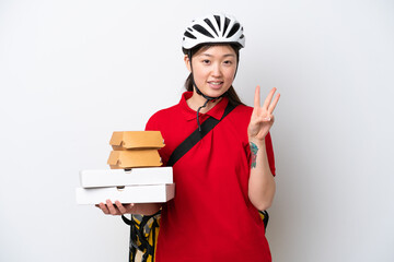 Young Chinese delivery woman taking takeaway food isolated on white background happy and counting three with fingers
