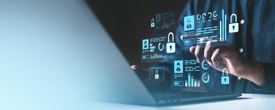Digital security concept with a man interacting with holographic locks and data icons on a laptop screen. - Powered by Adobe