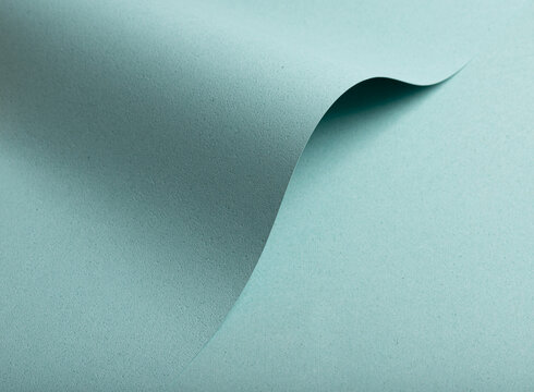 Fototapeta A pastel blue textured paper background featuring punched and perforated details, creating a unique design effect. The matte finish and soft tones contribute to a luxurious and minimalist aesthetic.