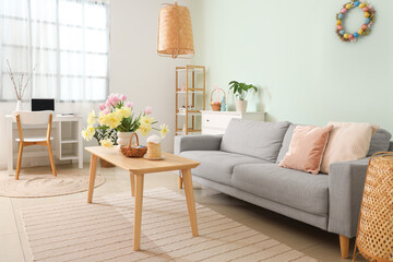 Modern living room with Easter basket and cake on table
