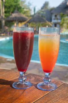 tropical cocktail at sunset in swimming pool bar in resort 