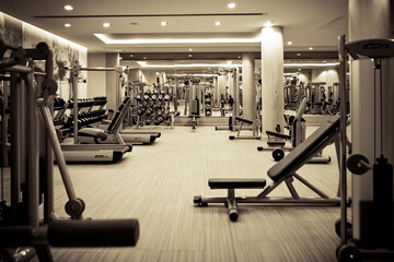 Fototapeta premium Modern gym interior with exercise equipment in use