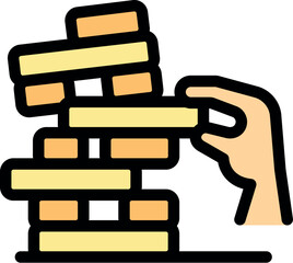 Hand carefully removing a block from a stacked tower game