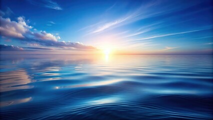 Obraz premium Serene Sunset Over Calm Ocean Waters With Soft Clouds And A Golden Glow Reflected In The Rippling Surface