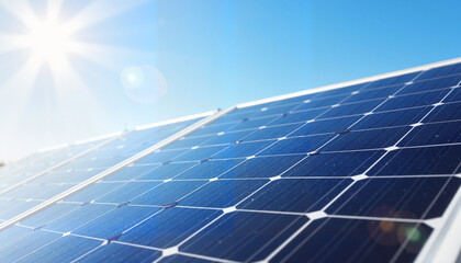 Rows of modern solar panels in open space under bright sunlight