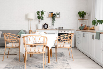 Interior of kitchen with white counters and dining table