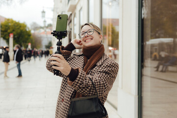Vlogger traveler woman recording video on phone share via app her travel vacation in the Lisbon....