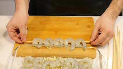 Chef prepares shrimp skewers for grilling marinating seafood with Seafood grilling process highlights fresh ingredients smoky aroma and culinary expertise Perfect seafood dish for barbecue lovers