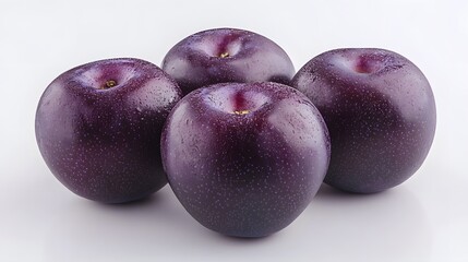 Obraz premium Four Dark Purple Plums Grouped Together