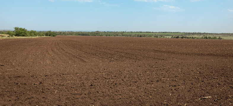 panoramic view of a agricultural plowed field background,  rural landscape