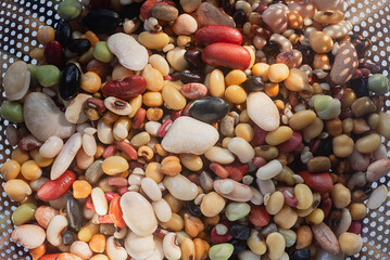 Mixed dried legumes: peas, lentils, beans, haricot, buckwheat, chickpea. food texture background, after soaking for 24 hour, Top view image.