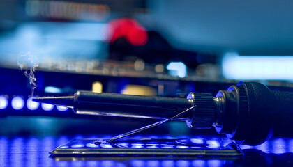 Macro View of Precision Soldering on a Circuit Board with a Soldering Iron Under Warm Ambient Light in a High-Tech Electronics Workshop