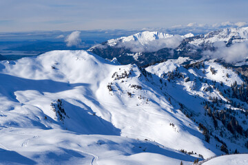 View from Maschgenkamm with beautiful snowy mountain panorama with lake at ski resort Flumserberg in the Swiss Alps on a sunny winter day. Photo taken January 29th, 2025, Flumserberg, Switzerland.