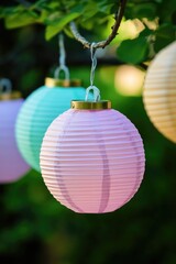 Obraz premium Paper lanterns suspended from a tree branch, colorful and festive