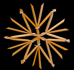 Obraz premium Straw Star Decoration isolated on black background. Snowflake toy
