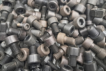Large black metal screws texture. Industrial steel bolts with deep threading. Heavy duty...