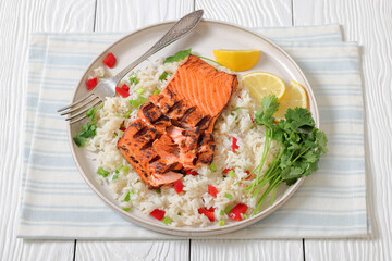 grilled red salmon fillet with rice, top view