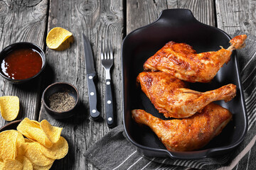 baked in oven three chicken leg quarters, top view