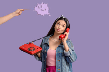 Young pin-up woman with GRL PWR sign talking by telephone on lilac background. Women's History Month
