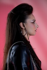 Stylish and Fashionable Profile Shot Showcasing An Edgy Aesthetic Against A Pink Background