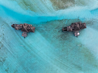Famous overwater bungalows villas in the Maldives Islands. Crystal clear water in the Indian Ocean. Amazing lagoons with sandy beaches.