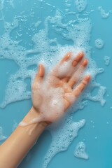Fototapeta premium Celebrating world hand hygiene day with soapy hand on blue background. Vertical banner. Copy space