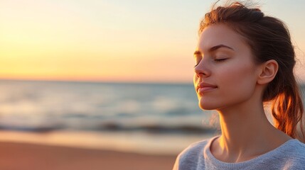 Woman meditating peacefully on beach at sunset, ocean waves in background, for wellness website