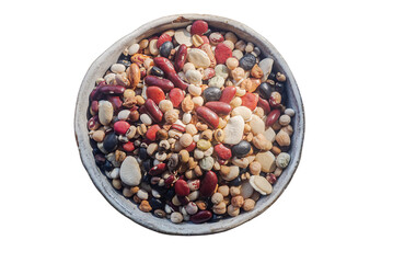 Mixed dried legumes: peas, lentils, beans, haricot, buckwheat, chickpea. in white pottery bowl isolate on white background.