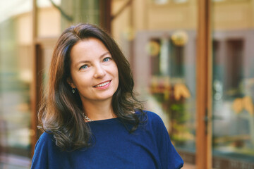 Outdoor close up portrait of beautiful mature 40 - 45  year old woman with brown hair