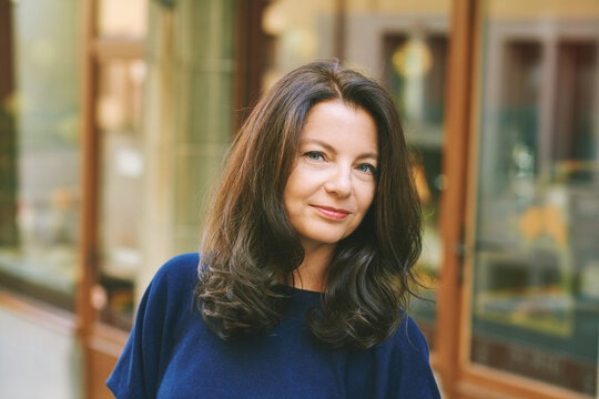 Outdoor close up portrait of beautiful mature 40 - 45  year old woman with brown hair