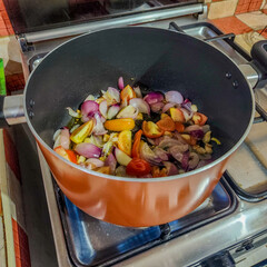 Vegetable aromatics such as onion, garlic and tomatoes being sautéed