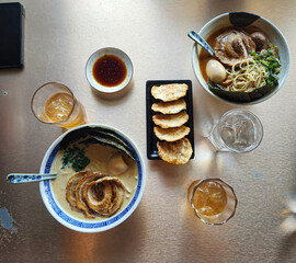 Ramens and gyoza served in the table.