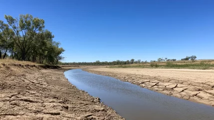 Fleecedeken met foto Drought-stricken riverbed in outback Australia, showing cracked earth and sparse vegetation under a clear sky  illustrating climate change impact © logitech