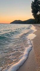 Serene sunset beach scene with gentle waves lapping sandy shore.