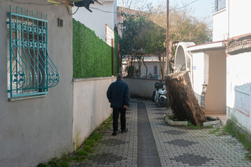 Man walking down narrow alley with greenery and motorbike from Istanbul, turkey